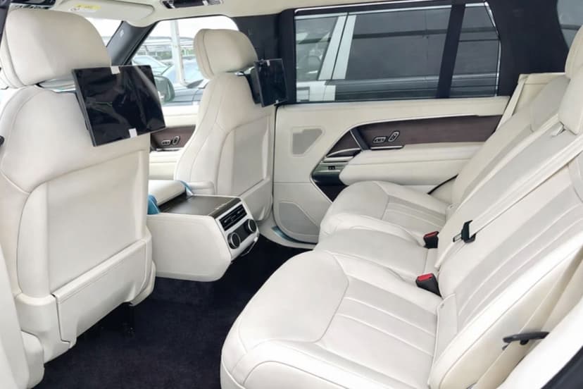Range Rover rear cabin with white leather and entertainment screens